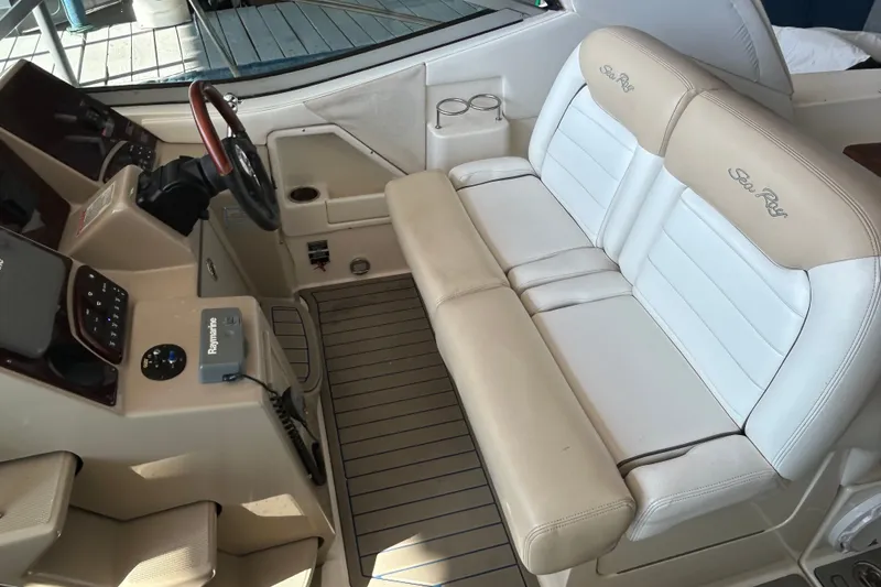 Slide: The Image of 2008 Sea Ray Sundancer 330 cockpit with beige seating and modern controls. - 18
