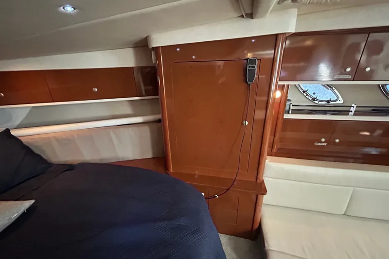 Slide: The Image of Interior of a 2008 Sea Ray Sundancer 330 with wood cabinetry and a bed. - 36