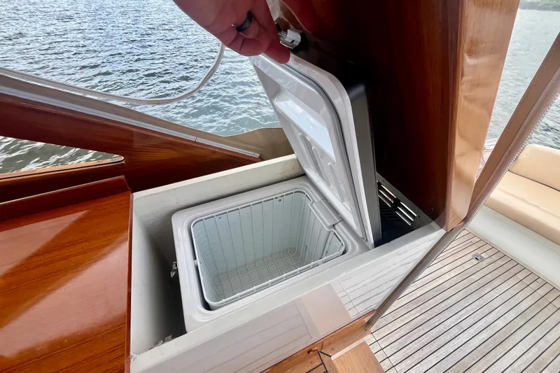 Slide: The Image of Open storage compartment on 2001 Little Harbor Whisper Jet 38 Prop boat, near water. - 32