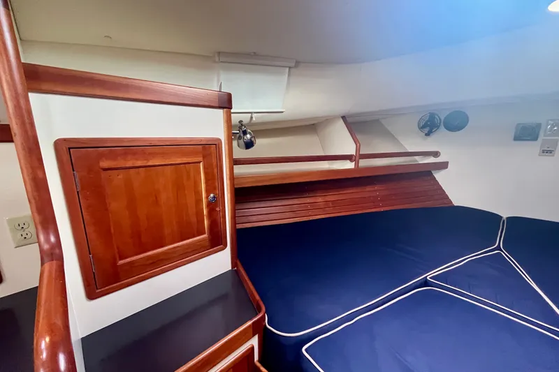 Slide: The Image of Interior cabin of 2001 Little Harbor Whisper Jet 38 Prop with wooden accents and blue cushions. - 20