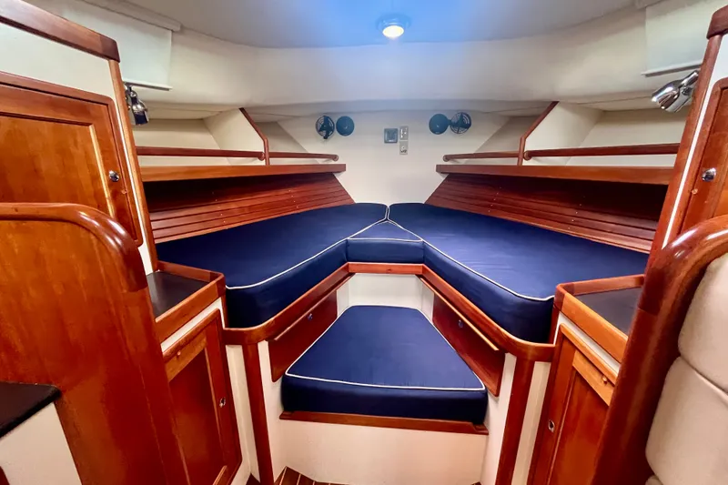 Slide: The Image of Luxurious cabin interior of 2001 Little Harbor Whisper Jet 38 Prop with blue cushions and wood finish. - 18