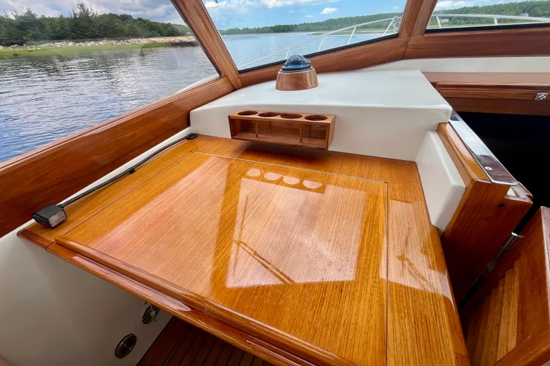 Slide: The Image of 2001 Little Harbor Whisper Jet 38 Prop cockpit with polished wood finish and scenic water view. - 15