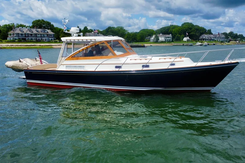 The Image of 2001 Little Harbor Whisper Jet 38 Prop boat on water, with scenic shoreline background. - 0