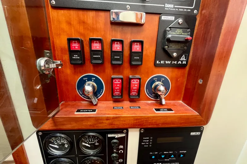 Slide: The Image of Control panel of a 2001 Little Harbor Whisper Jet 38 Prop boat with switches and gauges. - 35