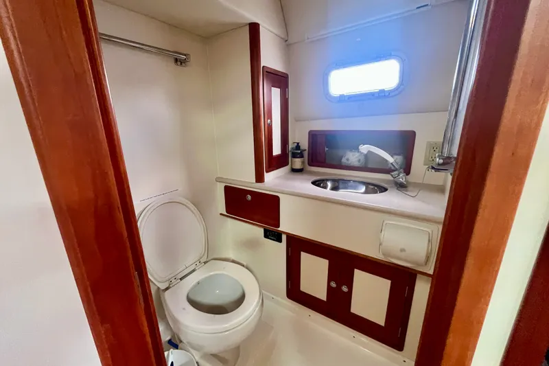 Slide: The Image of 2001 Little Harbor Whisper Jet 38 Prop bathroom with wooden accents and compact design. - 25