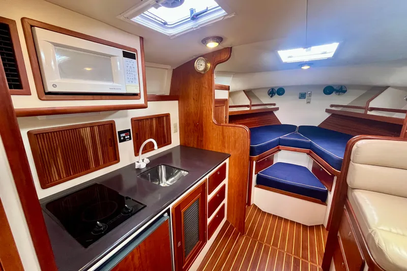 Slide: The Image of Luxurious interior of 2001 Little Harbor Whisper Jet 38 Prop with kitchenette and cozy seating. - 21