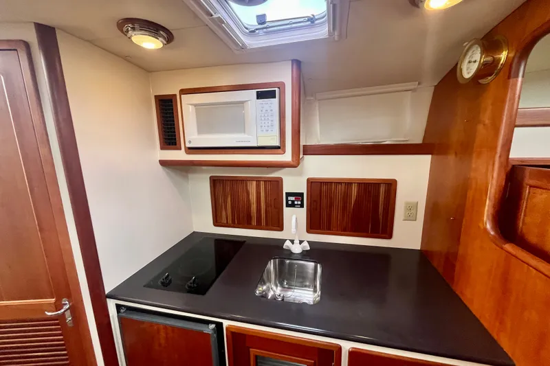 Slide: The Image of 2001 Little Harbor Whisper Jet 38 Prop galley with microwave, stove, and sink. - 22