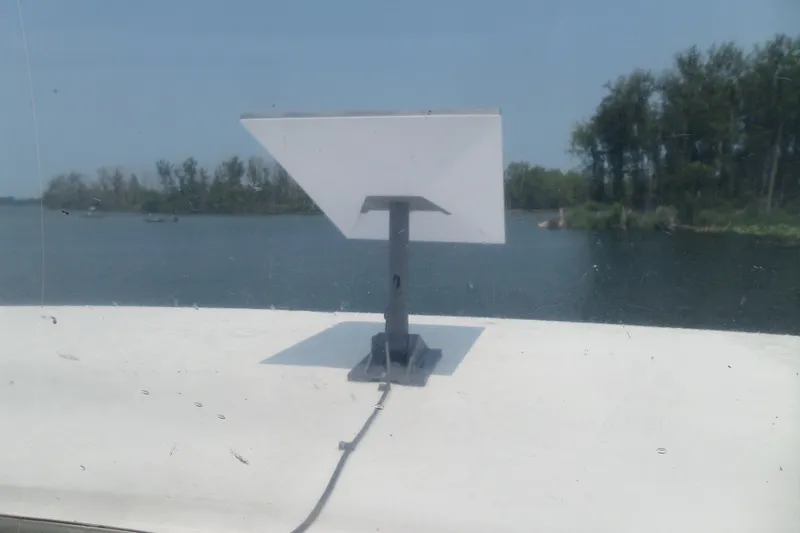 Slide: The Image of Satellite dish on 1994 Silverton 34 Aft Cabin Motor Yacht, with scenic water and trees background. - 15