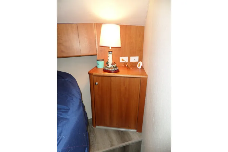 Slide: The Image of Cozy cabin interior of 1994 Silverton 34 Aft Cabin Motor Yacht with lamp and cabinet. - 53