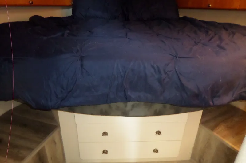 Slide: The Image of Interior cabin of 1994 Silverton 34 Aft Cabin Motor Yacht with blue bedding. - 51