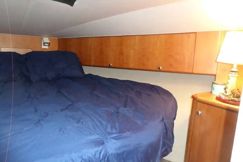 Slide: The Image of Cozy cabin interior of 1994 Silverton 34 Aft Cabin Motor Yacht with blue bedding. - 50