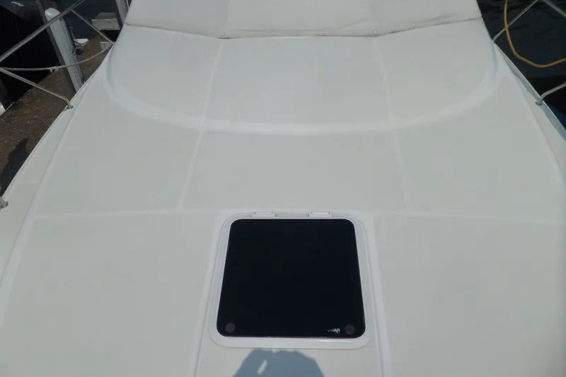 Slide: The Image of 1994 Silverton 34 Aft Cabin Motor Yacht deck with hatch, featuring clean white surface. - 70