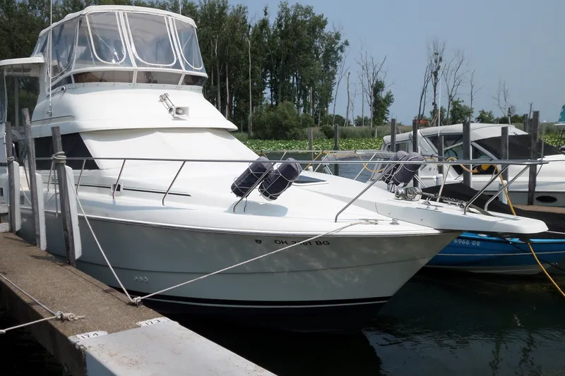 Slide: The Image of 1994 Silverton 34 Aft Cabin Motor Yacht docked at marina. - 2