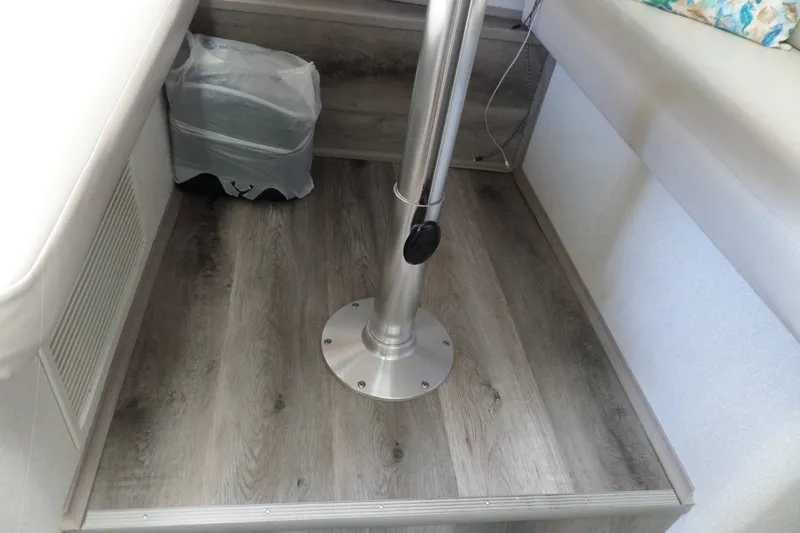 Slide: The Image of Interior of 1994 Silverton 34 Aft Cabin Motor Yacht with wood flooring and metal table base. - 55
