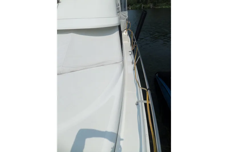 Slide: The Image of Side view of 1994 Silverton 34 Aft Cabin Motor Yacht docked on water. - 71