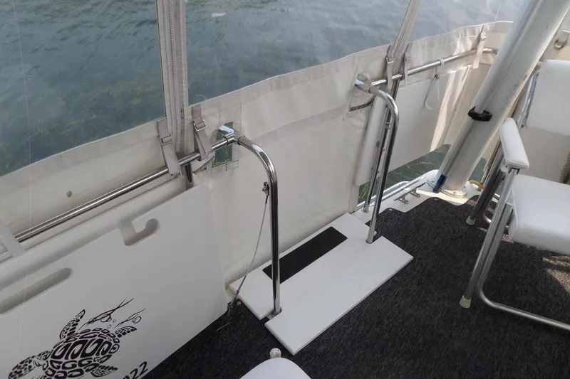 Slide: The Image of Interior view of 1994 Silverton 34 Aft Cabin Motor Yacht with seating and railing. - 26
