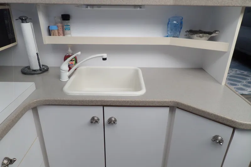 Slide: The Image of Compact kitchen sink area in a 1994 Silverton 34 Aft Cabin Motor Yacht. - 37