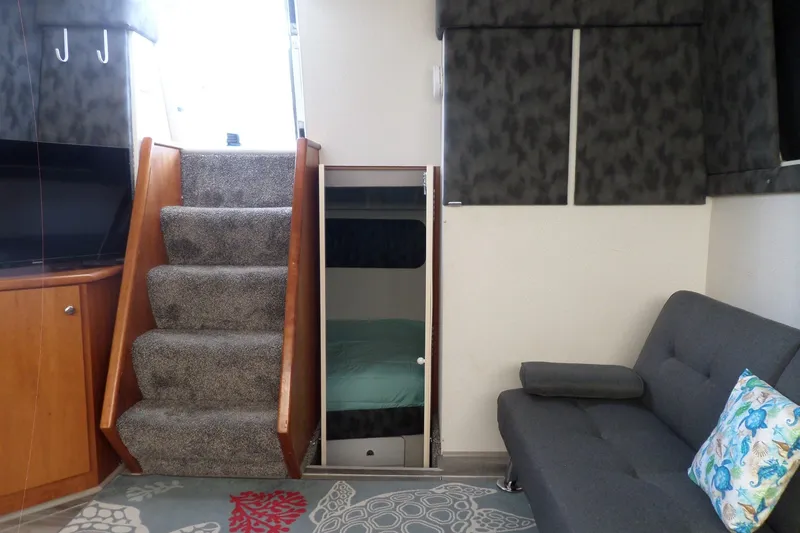 Slide: The Image of Interior of 1994 Silverton 34 Aft Cabin Motor Yacht with stairs, sofa, and bunk bed. - 40