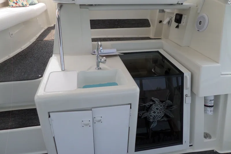 Slide: The Image of 1994 Silverton 34 Aft Cabin Motor Yacht interior with sink and turtle design glass panel. - 20