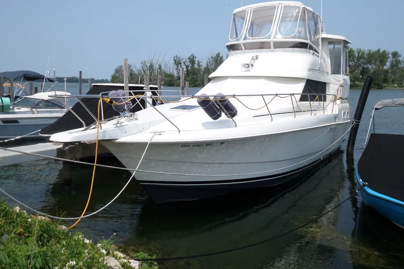 Slide: The Image of 1994 Silverton 34 Aft Cabin Motor Yacht docked at marina. - 1