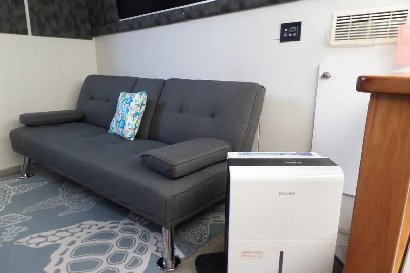 Slide: The Image of Gray sofa and dehumidifier in 1994 Silverton 34 Aft Cabin Motor Yacht interior. - 39