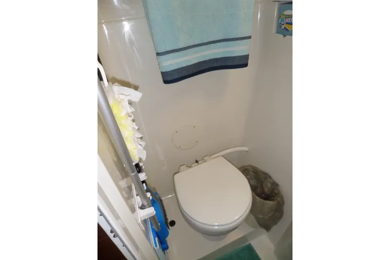 Slide: The Image of Bathroom of 1994 Silverton 34 Aft Cabin Motor Yacht with toilet and towel. - 64