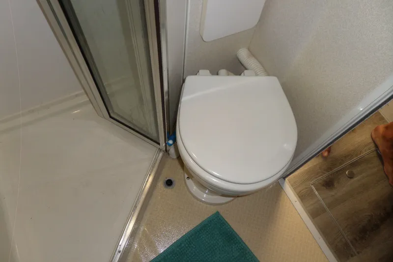 Slide: The Image of 1994 Silverton 34 Aft Cabin Motor Yacht bathroom with toilet and shower. - 47