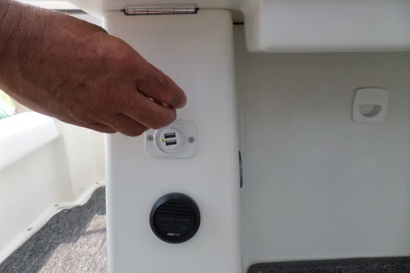 Slide: The Image of Hand adjusting USB port on 1994 Silverton 34 Aft Cabin Motor Yacht interior. - 9