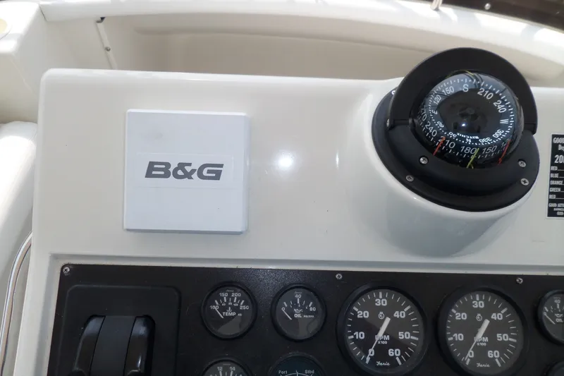 Slide: The Image of Control panel of a 1994 Silverton 34 Aft Cabin Motor Yacht with compass and gauges. - 6