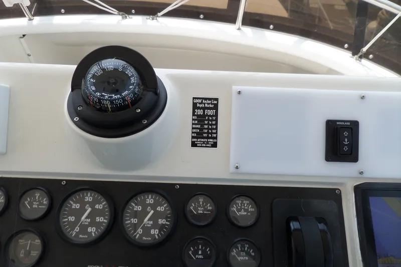 Slide: The Image of 1994 Silverton 34 Aft Cabin Motor Yacht dashboard with compass and gauges. - 5