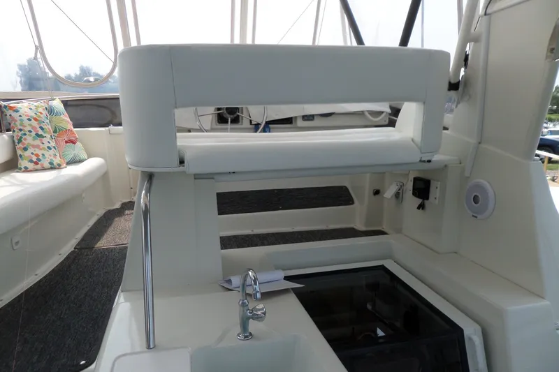Slide: The Image of 1994 Silverton 34 Aft Cabin Motor Yacht interior with seating and helm station. - 19