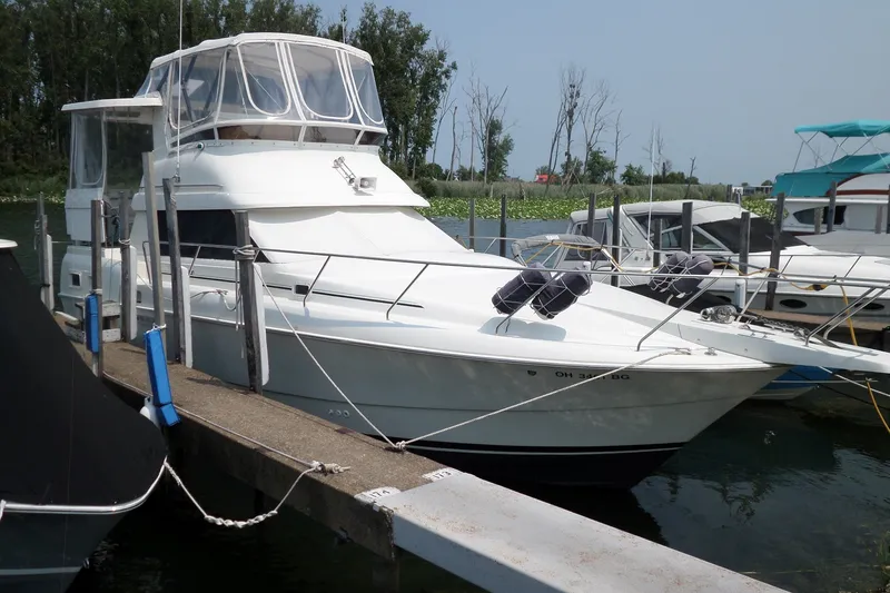 The Image of 1994 Silverton 34 Aft Cabin Motor Yacht docked at marina, side view. - 0