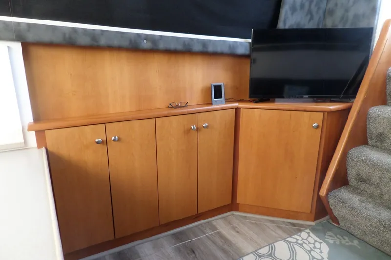 Slide: The Image of Interior of 1994 Silverton 34 Aft Cabin Motor Yacht with wooden cabinets and TV. - 42