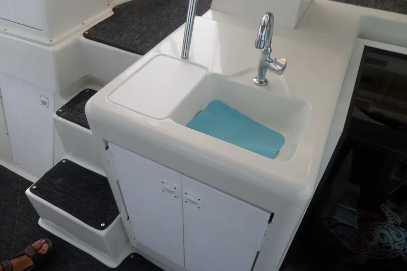 Slide: The Image of Sink and cabinet on 1994 Silverton 34 Aft Cabin Motor Yacht, with adjacent carpeted steps. - 23