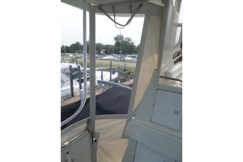 Slide: The Image of 1994 Silverton 34 Aft Cabin Motor Yacht interior view with marina background. - 18