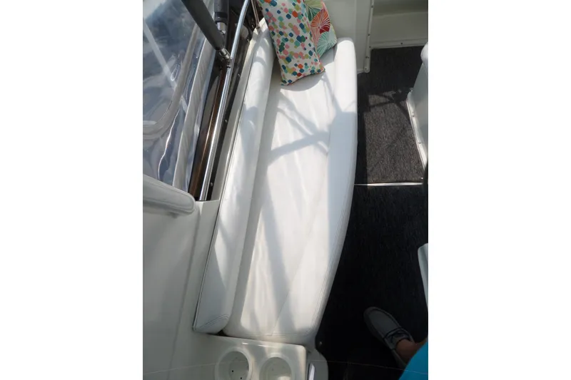 Slide: The Image of 1994 Silverton 34 Aft Cabin Motor Yacht interior with white seating and colorful pillow. - 14