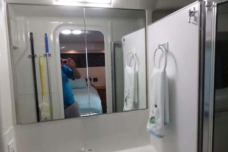 Slide: The Image of Bathroom interior of 1994 Silverton 34 Aft Cabin Motor Yacht with mirror and towels. - 67