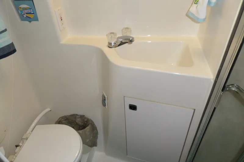 Slide: The Image of Bathroom interior of 1994 Silverton 34 Aft Cabin Motor Yacht, featuring sink and toilet. - 65