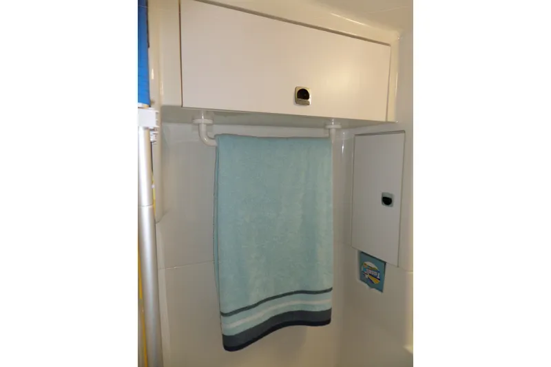 Slide: The Image of Bathroom storage area in 1994 Silverton 34 Aft Cabin Motor Yacht with towel and cabinets. - 63