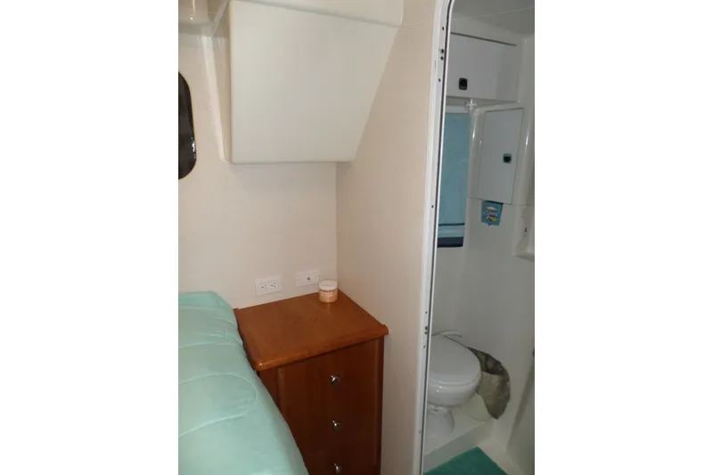 Slide: The Image of 1994 Silverton 34 Aft Cabin Motor Yacht interior with bathroom and wooden cabinet. - 61