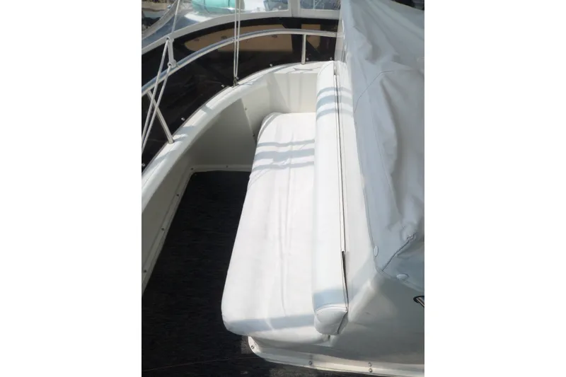 Slide: The Image of 1994 Silverton 34 Aft Cabin Motor Yacht seating area with white upholstery. - 11