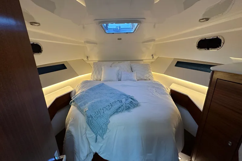 Slide: The Image of Luxurious cabin interior of 2024 Pursuit OS 445 Offshore yacht with cozy bedding. - 67