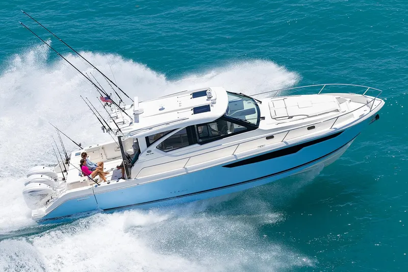 Slide: The Image of Manufacturer Provided Image: 2024 Pursuit OS 445 Offshore boat cruising on blue ocean water. - 74