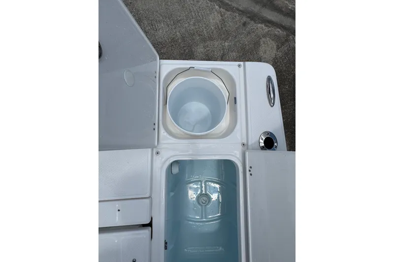 Slide: The Image of 2026 Robalo 226 Cayman boat storage compartments and livewell on deck. - 20