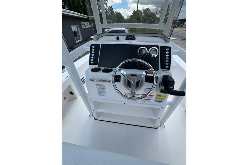Slide: The Image of 2026 Robalo 226 Cayman boat dashboard with steering wheel and controls. - 15