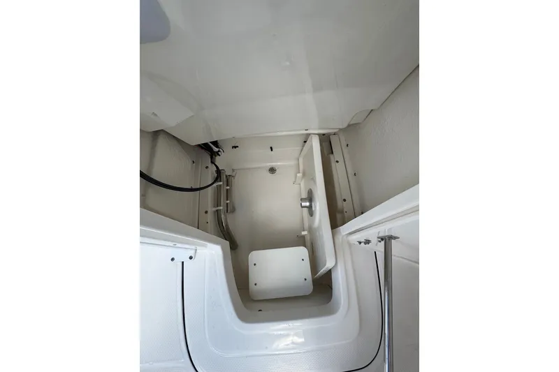 Slide: The Image of Interior view of 2026 Robalo 226 Cayman boat storage compartment. - 14