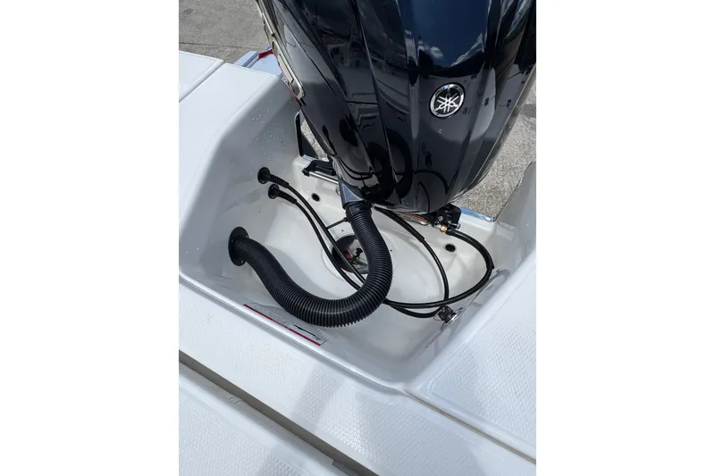 Slide: The Image of 2026 Robalo 226 Cayman boat engine compartment with Yamaha motor and cables. - 21