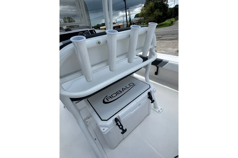 Slide: The Image of 2026 Robalo 226 Cayman boat interior with rod holders and storage compartment. - 22