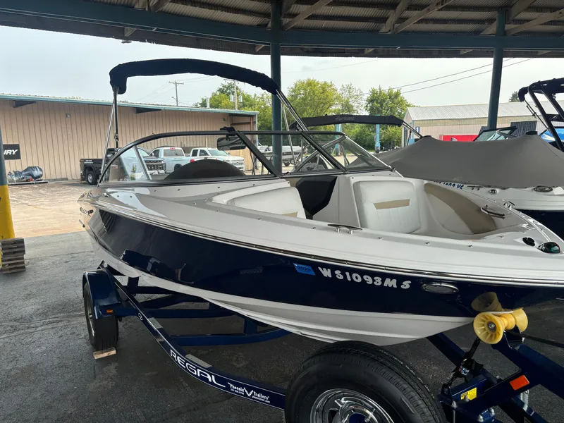 Slide: The Image of A 2017 Regal 1900 ES Bowrider sits on a trailer in a covered area. - 1