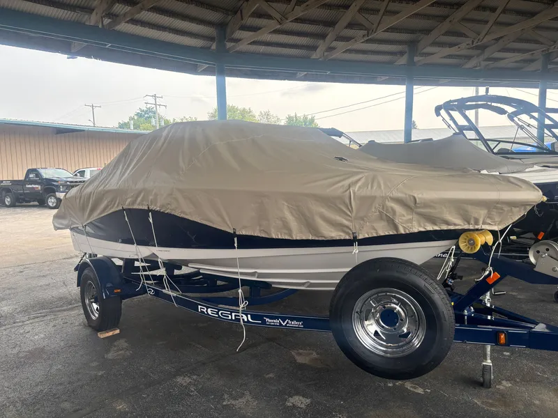 Slide: The Image of A 2017 Regal 1900 ES Bowrider on a trailer, covered with a tarp. - 19